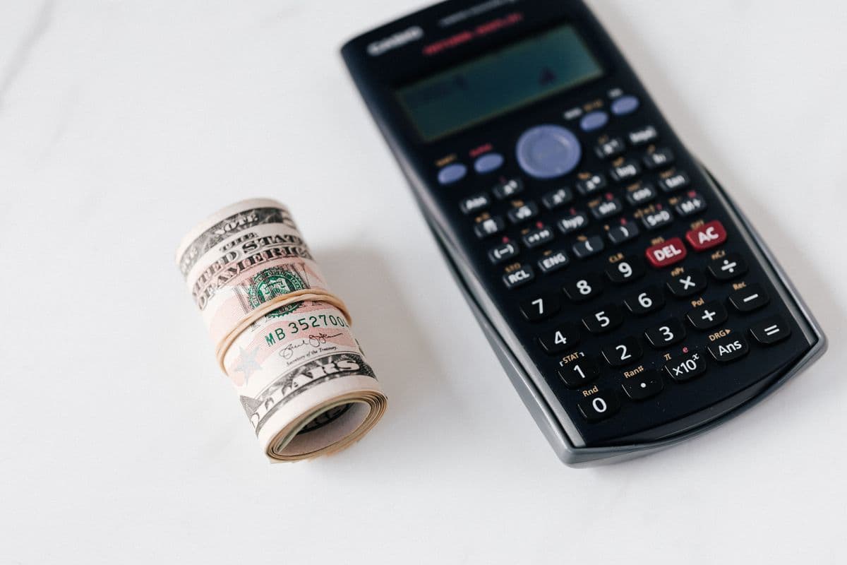 Cash and calculator representing CD interest planning