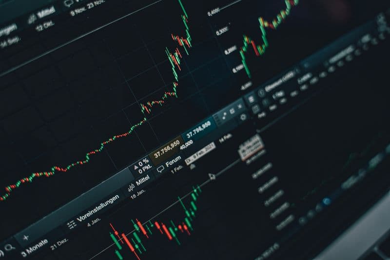 Stock market trading charts on a laptop screen