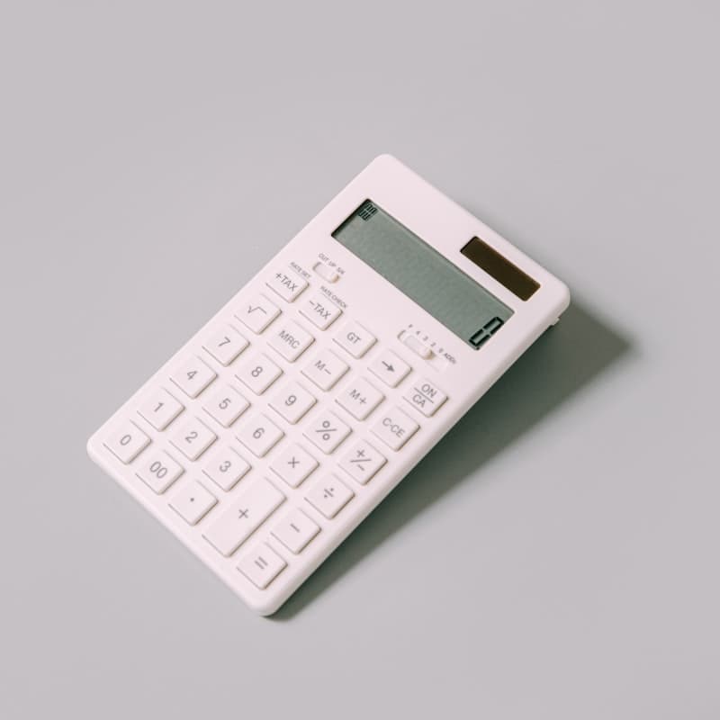 Person reviewing financial documents with a calculator